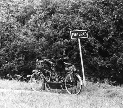 [a picture of an empty tandem bicycle, waiting  in the Dutch
    countryside]