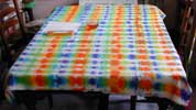 [a picture of an empty table with a tie-dye tablecloth]