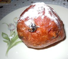 [deep-fried ball of sweet yeast dough with raisins]