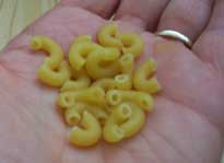 [a handful of elbow macaroni pasta]