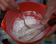 [a bowl of whipped cream, with whisk and spoon]