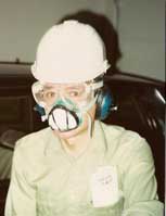 [Safety First: A well-protected worker, wearinng
    Safety glasses, dust mask, helmet,
  hearing protection]