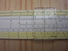[a detailed view of a slide rule showing how it works]